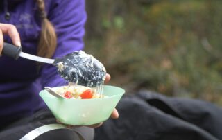 food being served in a bowl by a person