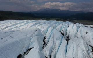 blue ice fins on glacier and mountains