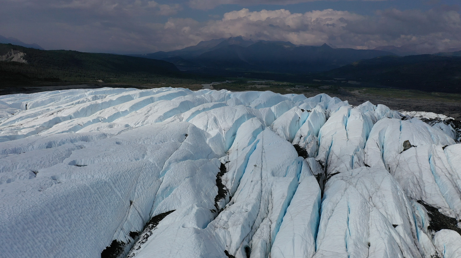 blue ice fins on glacier and mountains