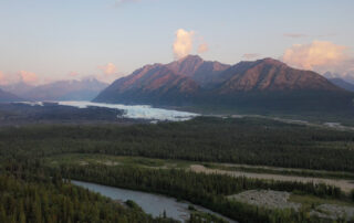 Alaska mountains at sunset with glacier in valley below
